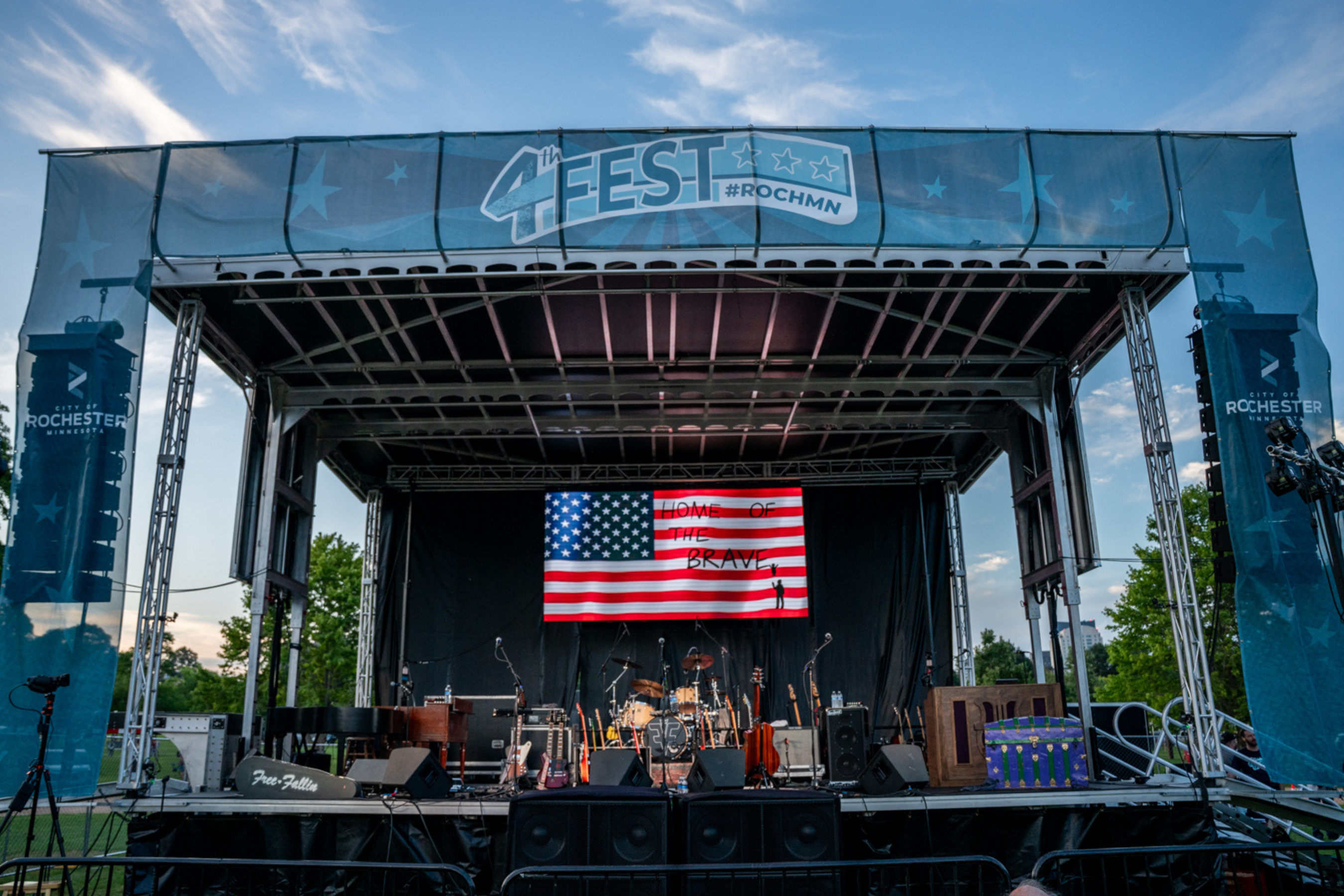 a stage with instruments and an american flag and the words '4th fest #rochmn'