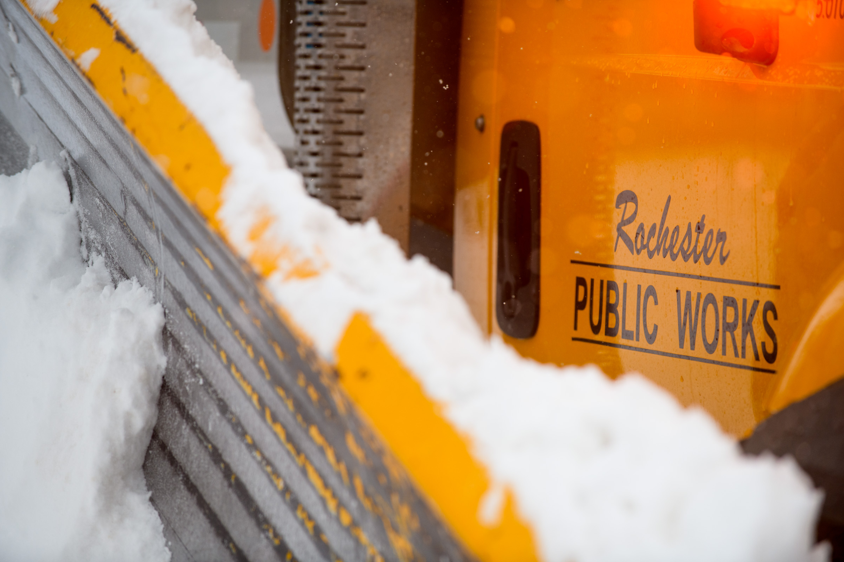 close up of "rochester public works" on the side of a snowy plow blade