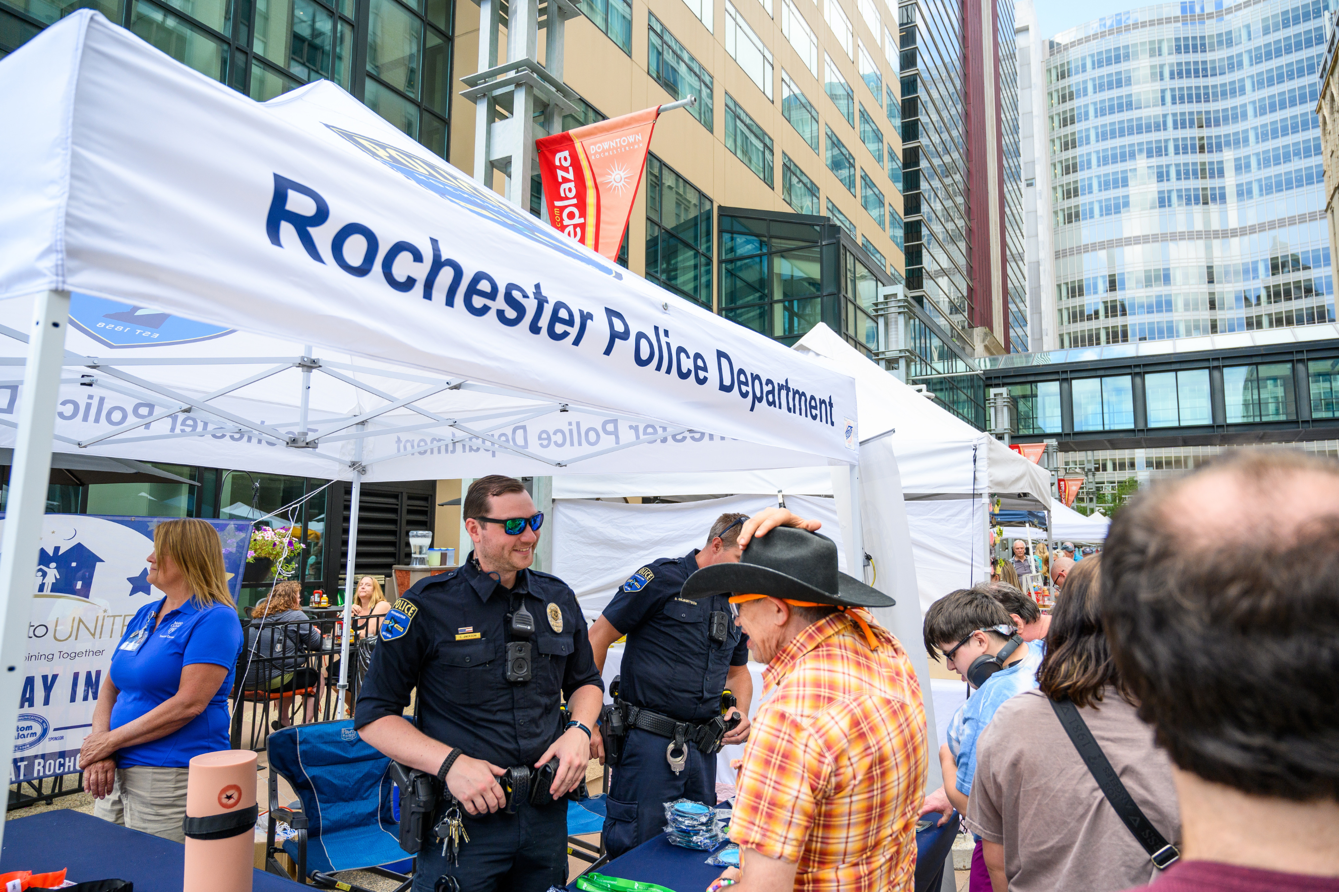 rpd officers at a tent during a downtown engagement event interacting with the public