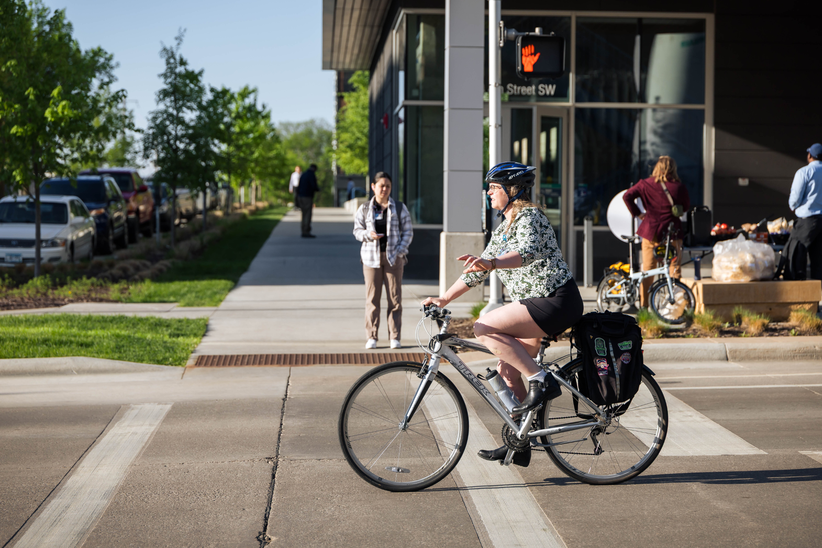 a person biking on a downtown rochester street during the day