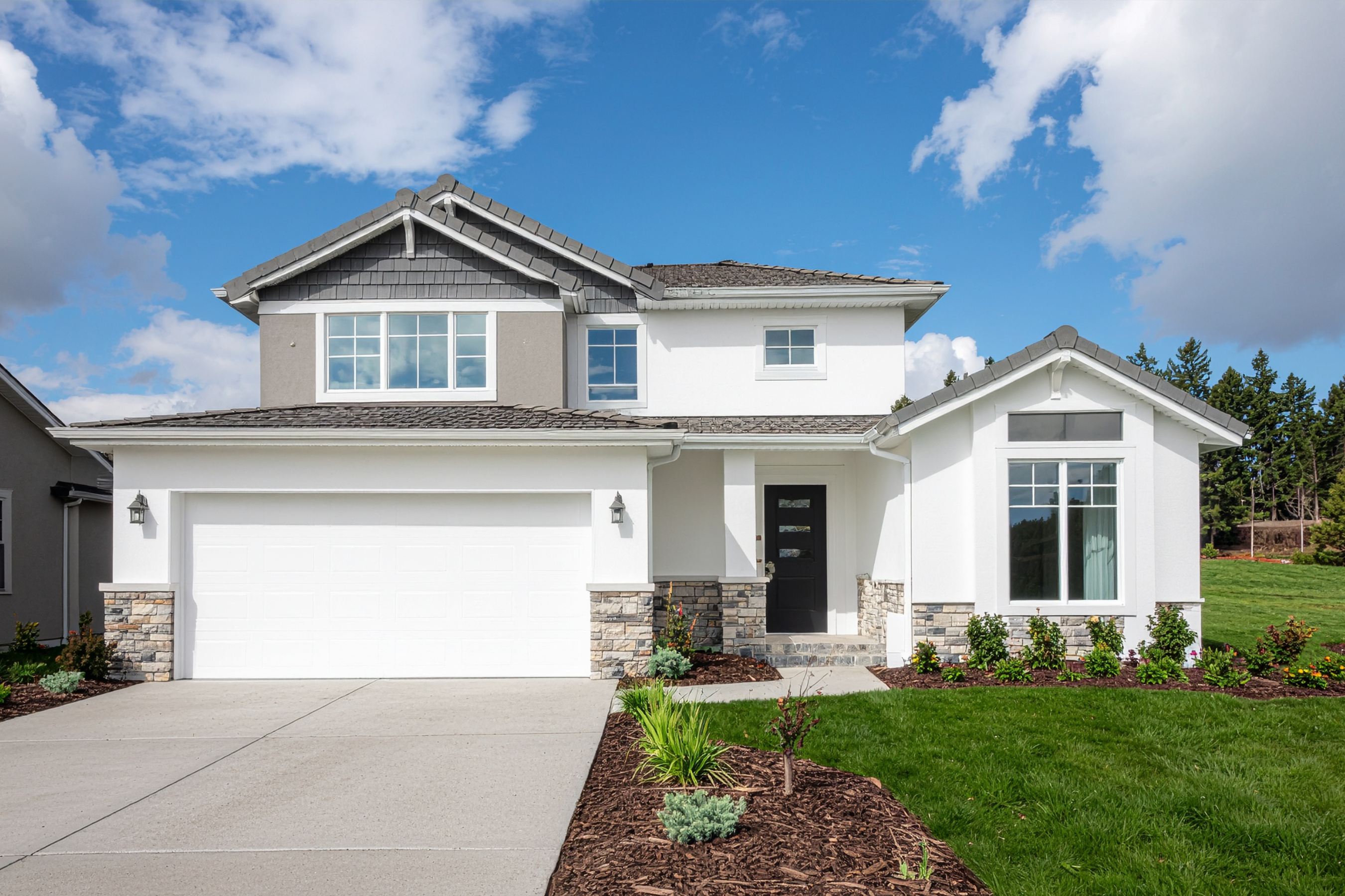 white, two story house with two car garage and driveway