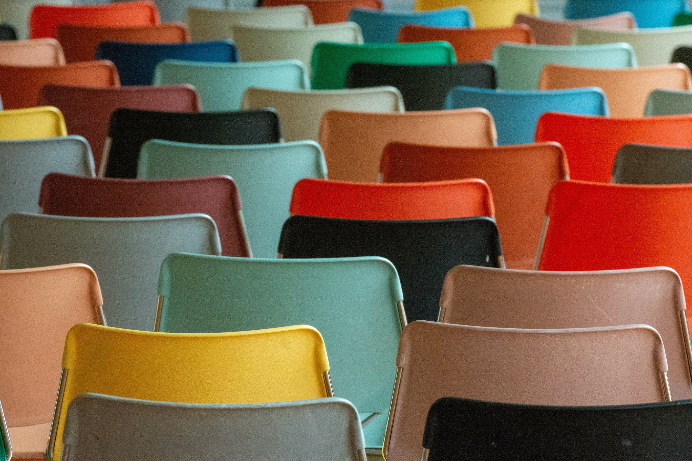 chairs of multiple colors lined up and facing away from the camera