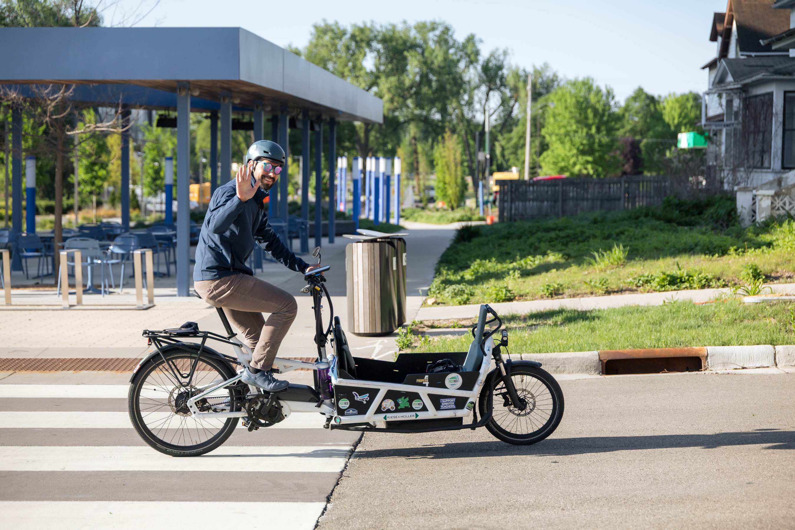 man riding on adaptive bike and waving at the camera