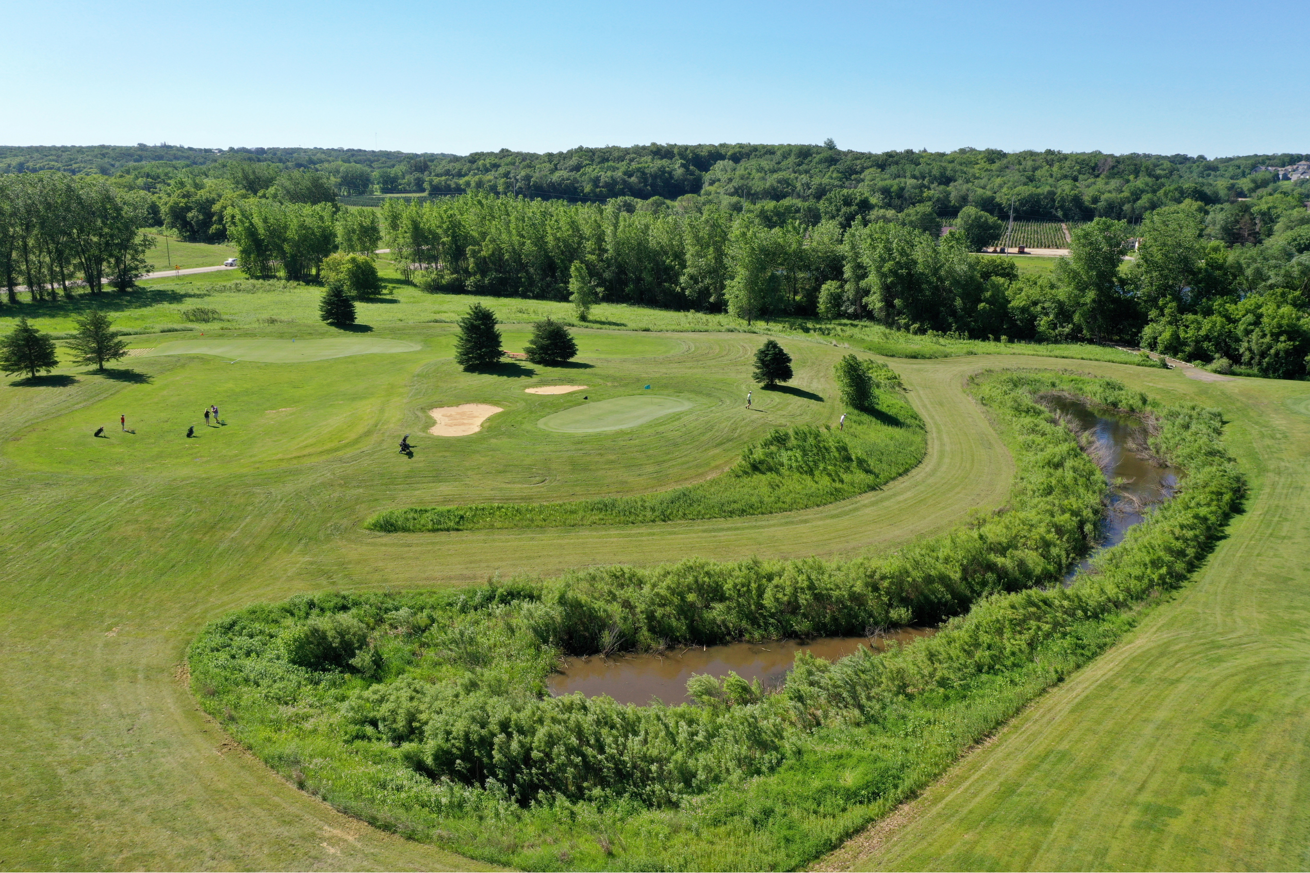 drone shot of fairway, green, sand trap and pond at Hadley Creek Golf Course