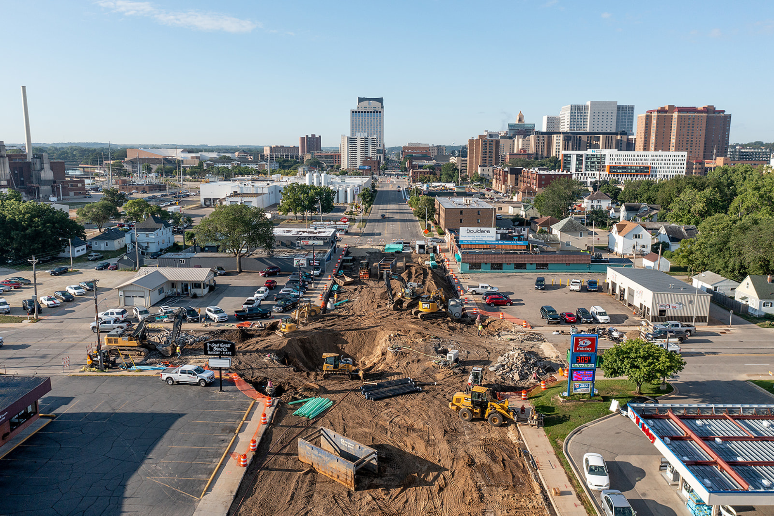 drone view of north broadway avenue in the middle of construction with multiple pieces of equipment working on the roadway