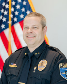headshot of Chief Jim Franklin in front of an American flag