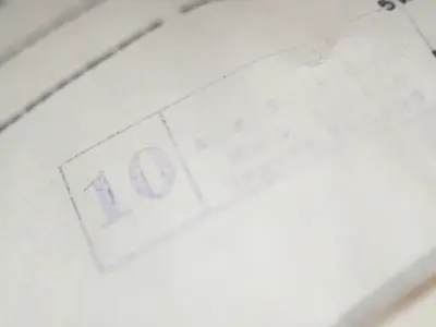 a piece of paper with a faded stamp in blue ink