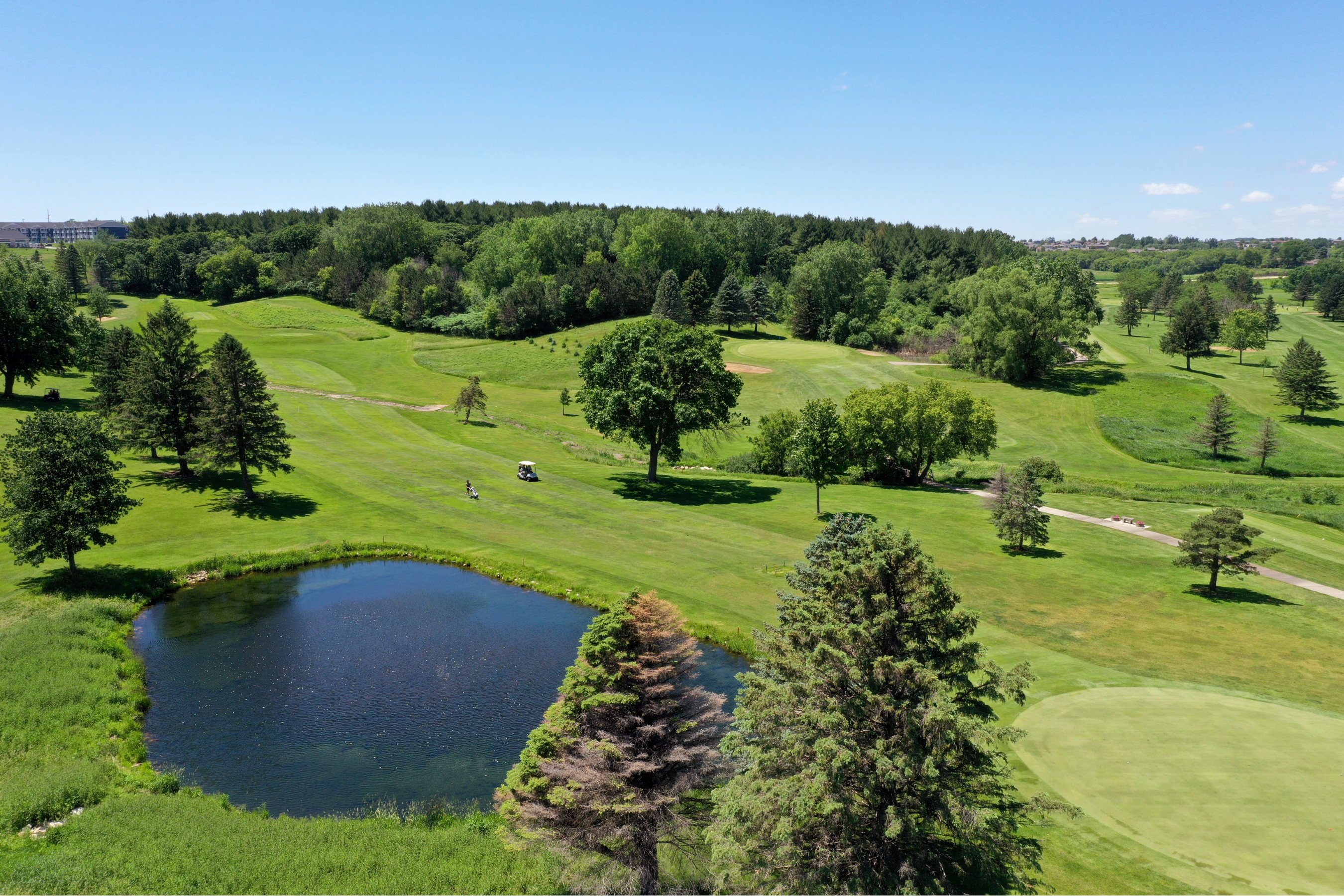 drone view of fairway, green and pond at Northern Hills Golf Course