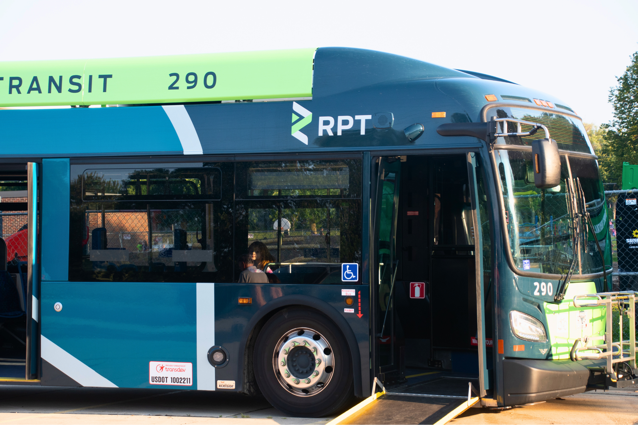 Front end of an RPT bus with the front door open and the accessibility ramp down