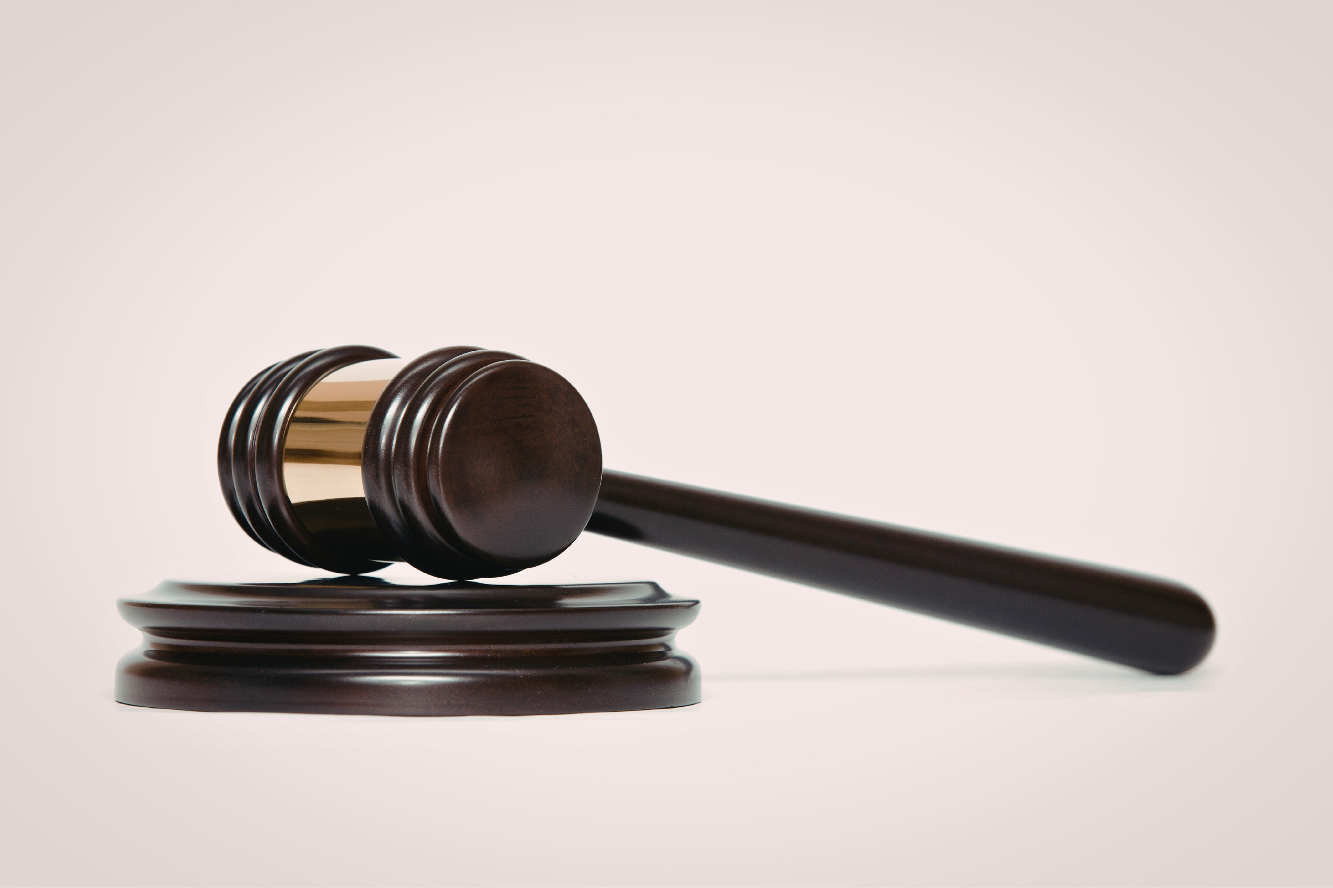 a wooden gavel on a plain white background