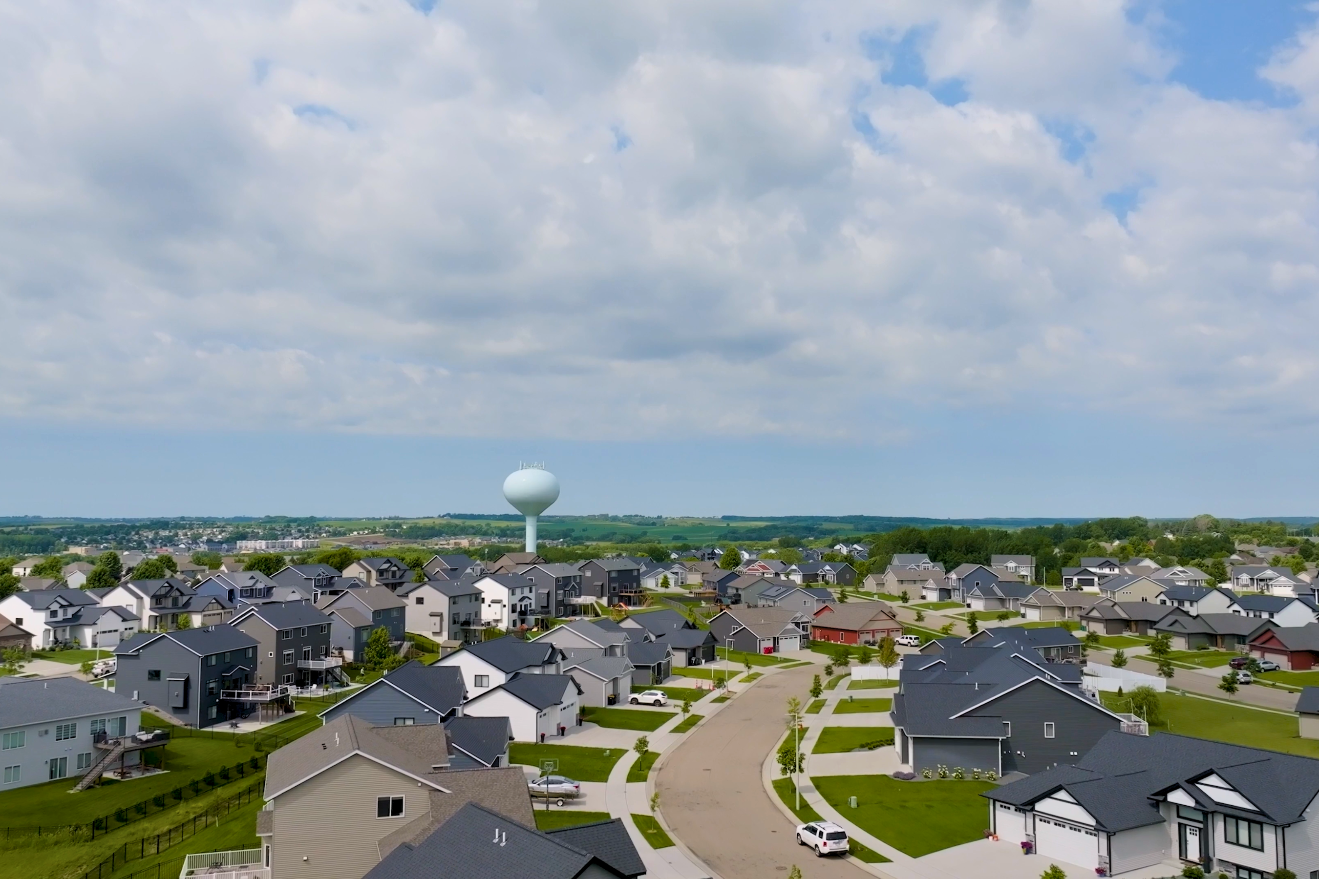drone shot of many houses and a water tower