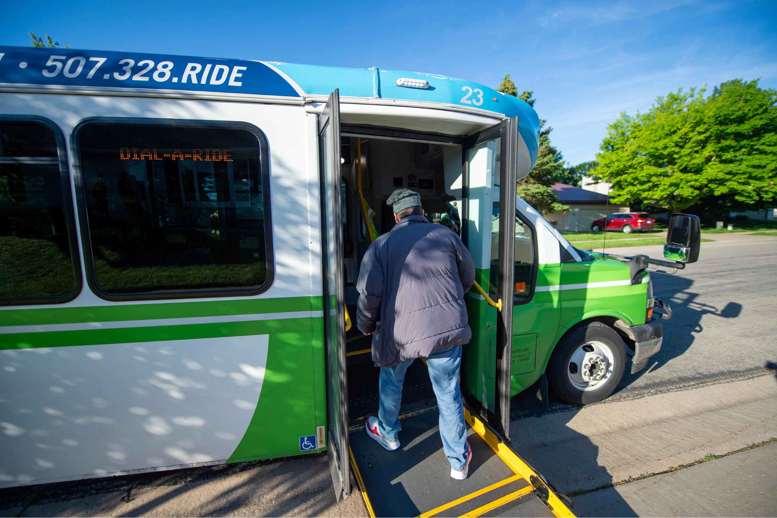 a person entering a zips paratransit bus via an accessible ramp