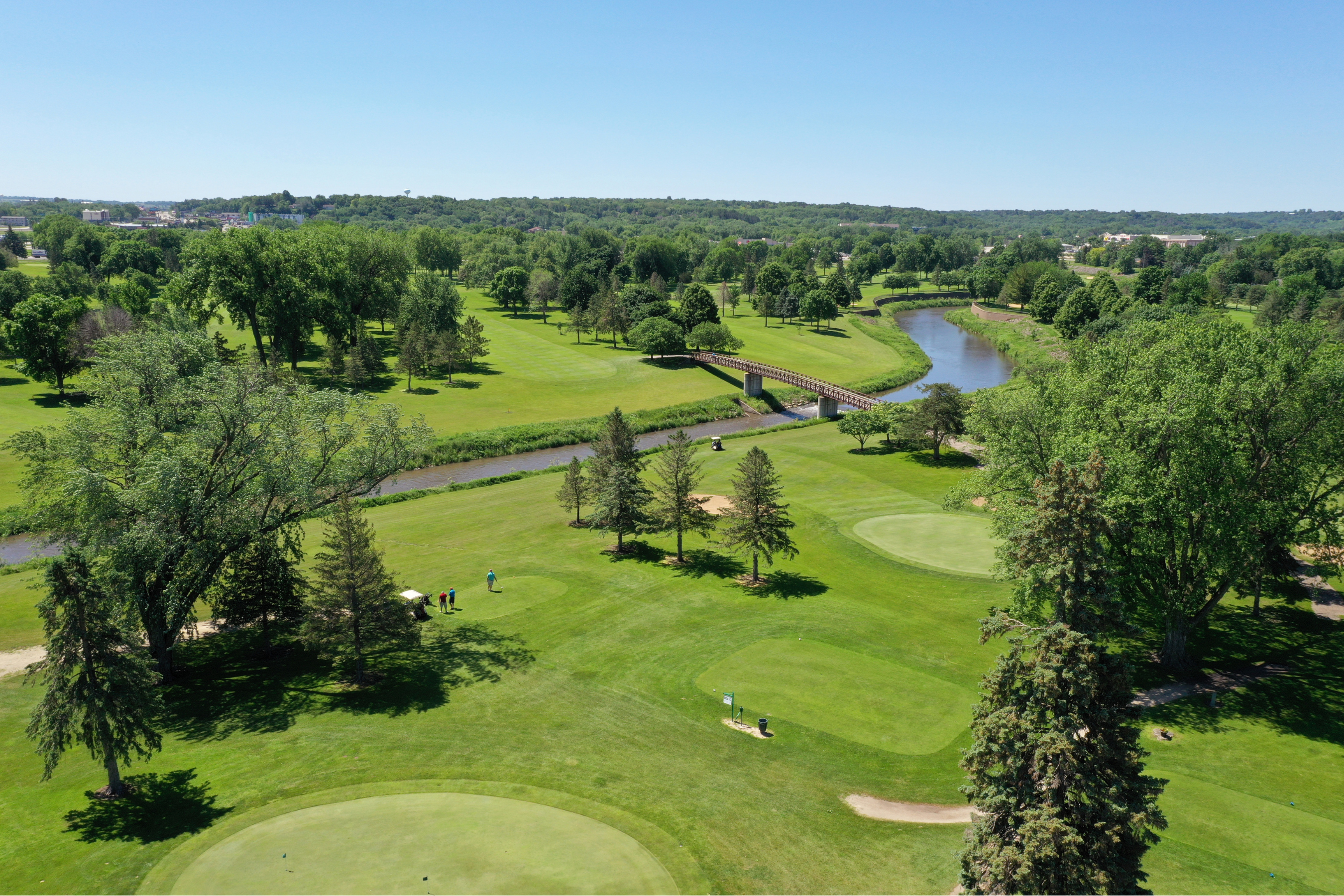 drone view of green, fairway, river and bridge at Soldiers Field Golf Course