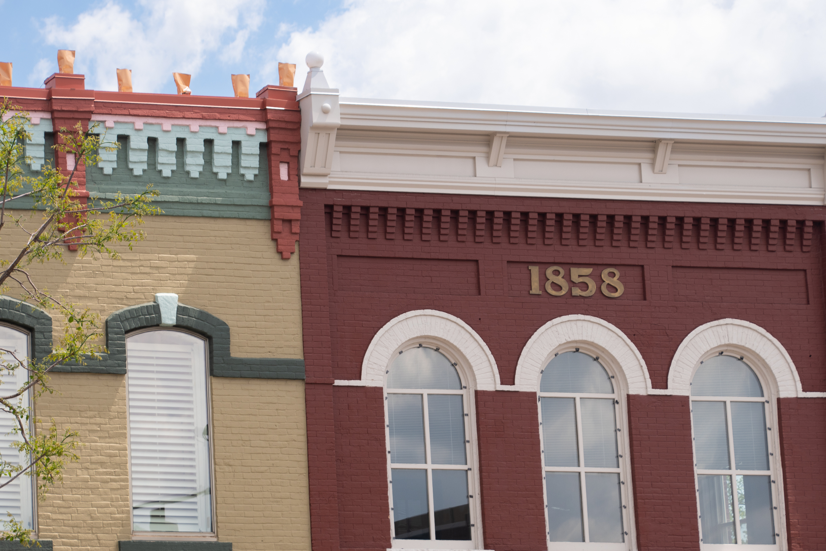 brick buildings in downtown rochester, one with the number '1858'