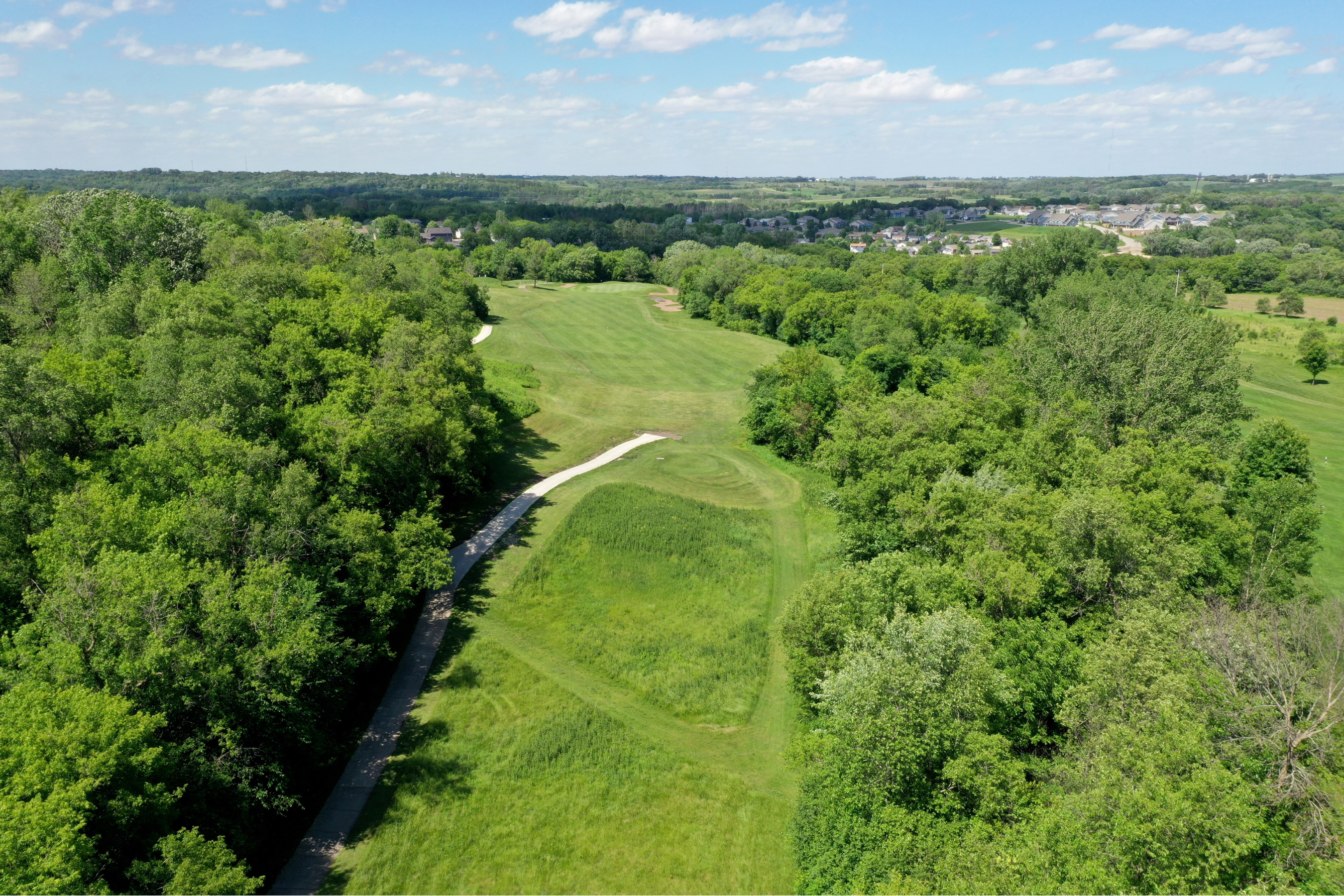 drone view of a fairway at Eastwood Golf Course on a blue skied, partly cloudy day