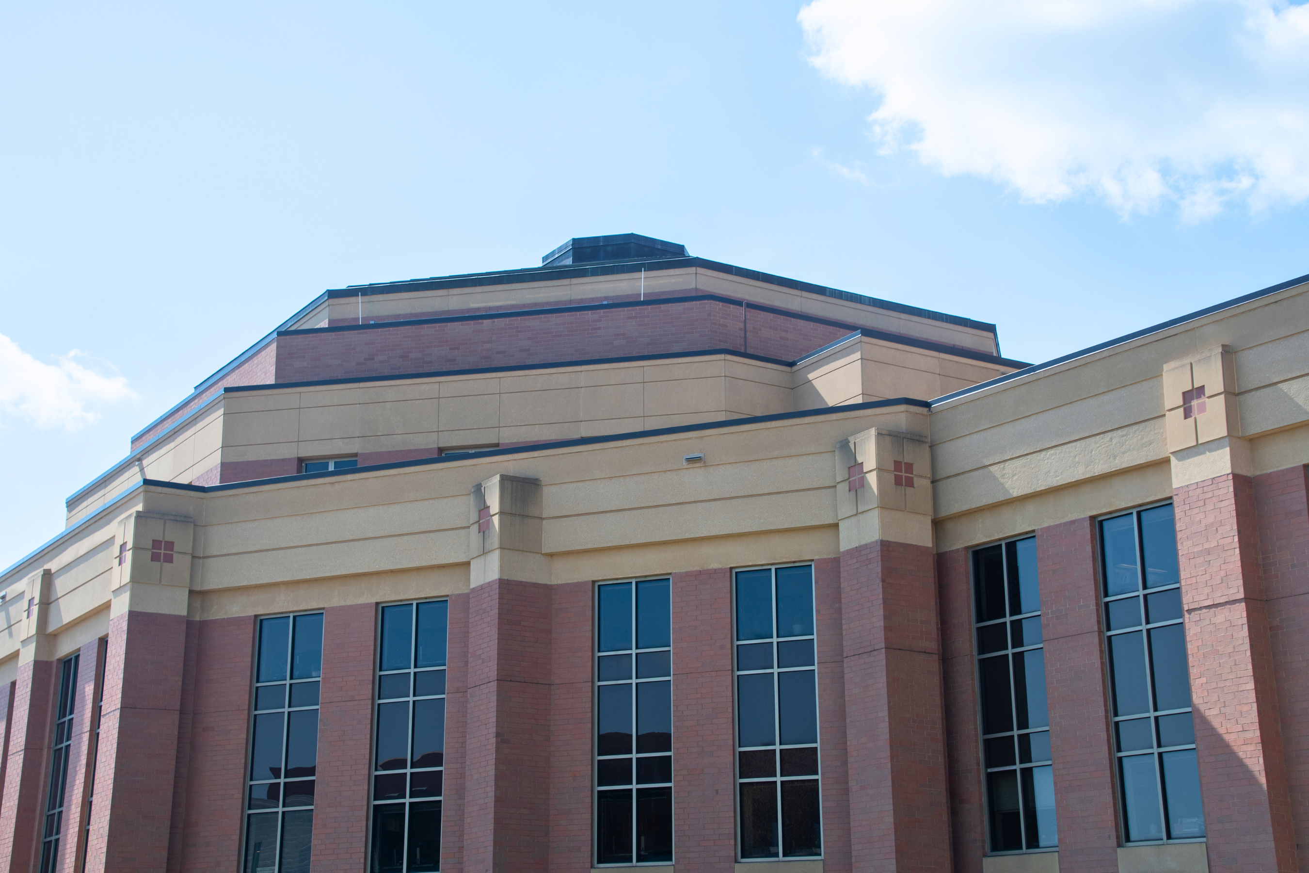 view looking up at city hall from the exterior on a blue skied day