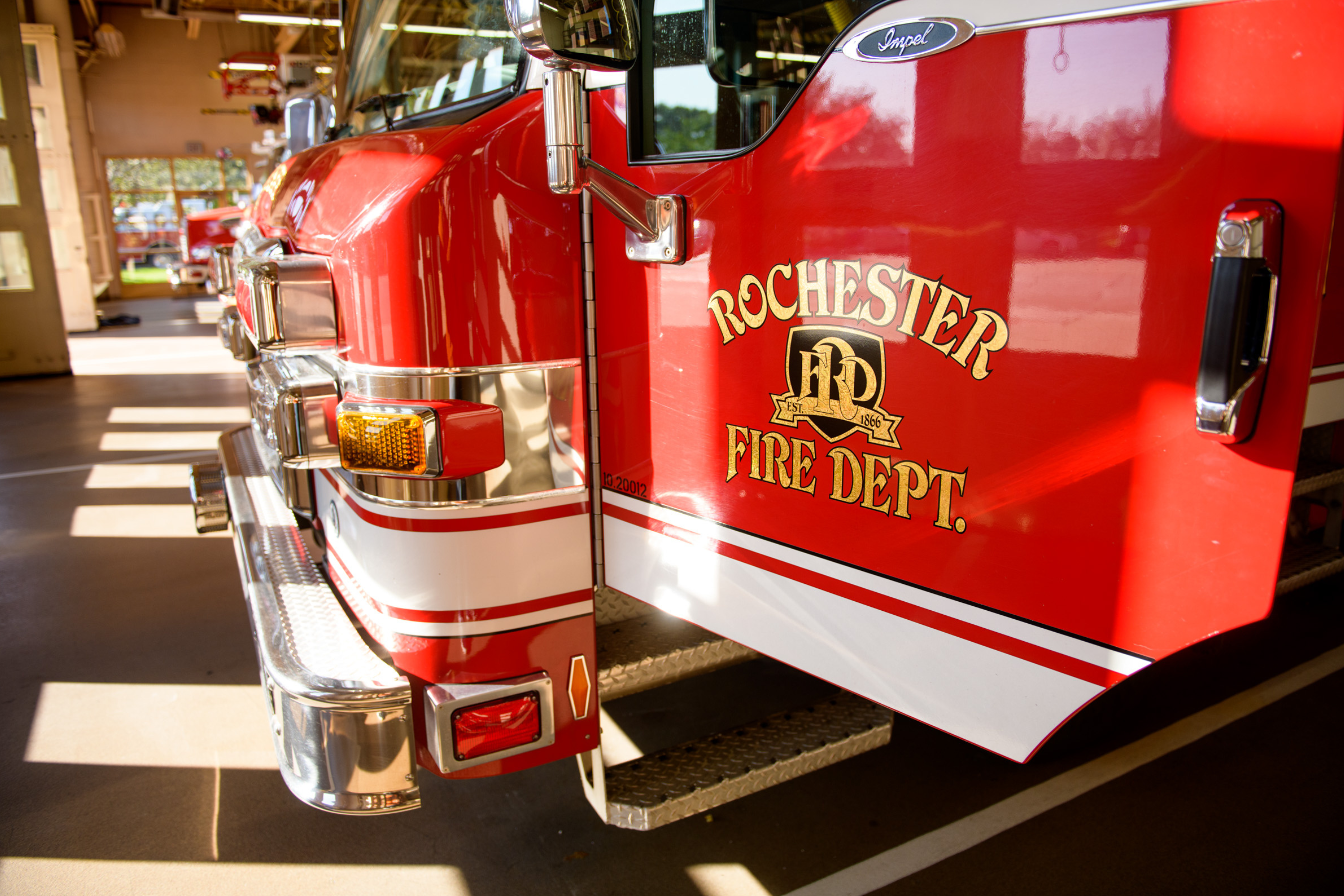 red fire truck with "Rochester Fire Dept." on the door